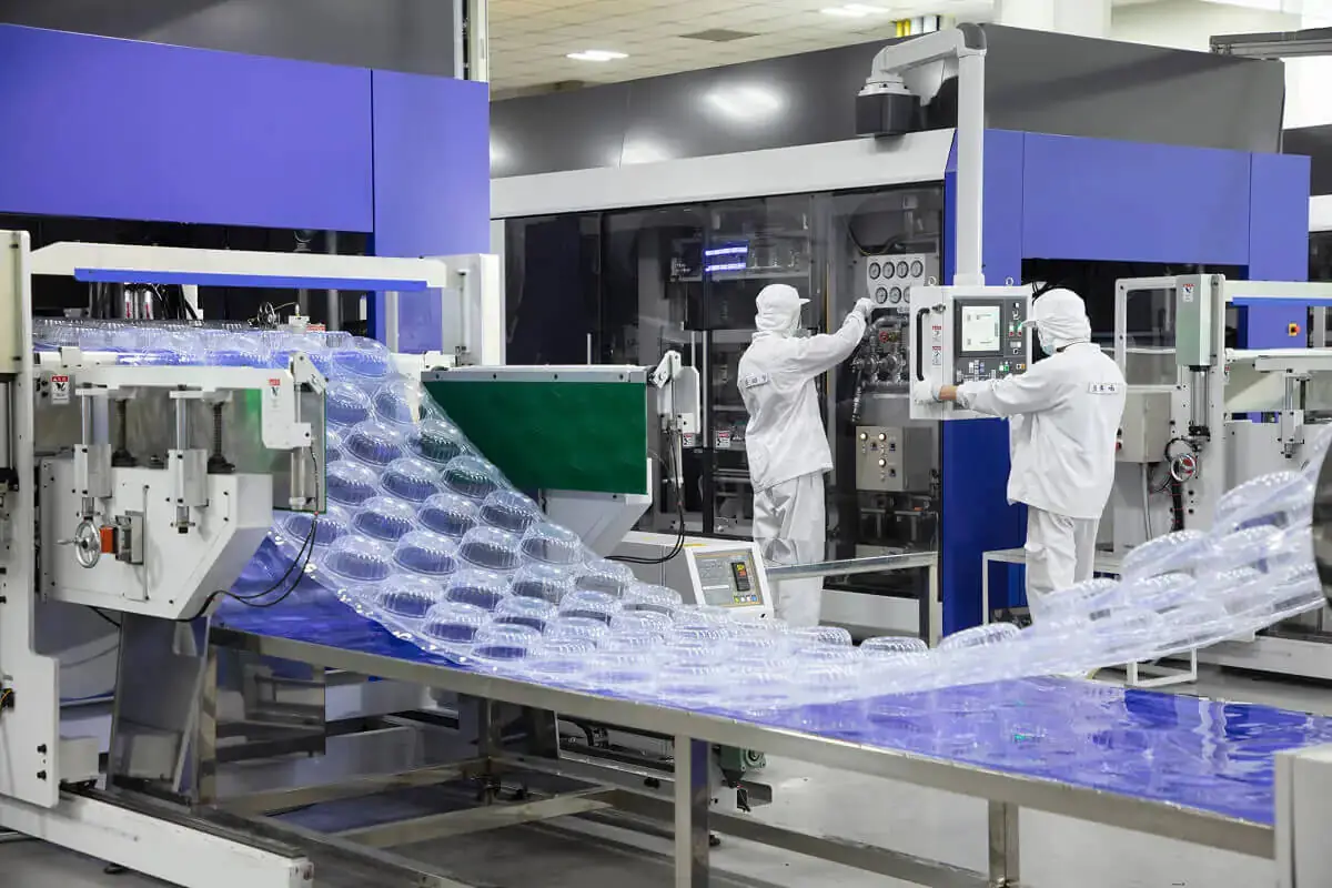 South Plastic automated thermoforming production line manufacturing transparent plastic food packaging containers.